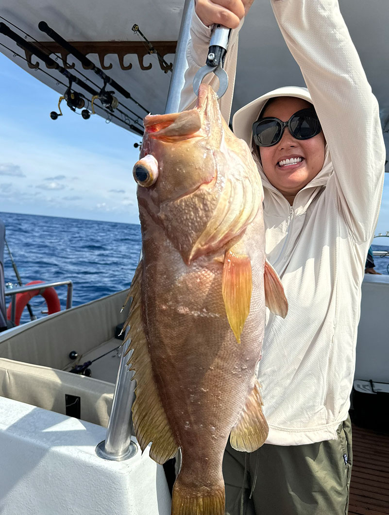 Angler holding a red grouper